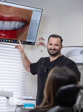 A dentist showing a patient their planned smile chairside.